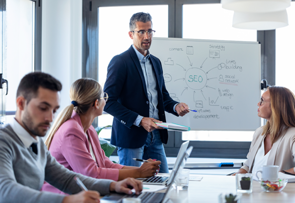 Businessman explaining SEo to a group