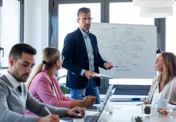 Businessman explaining SEo to a group