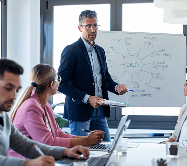 Businessman explaining SEo to a group