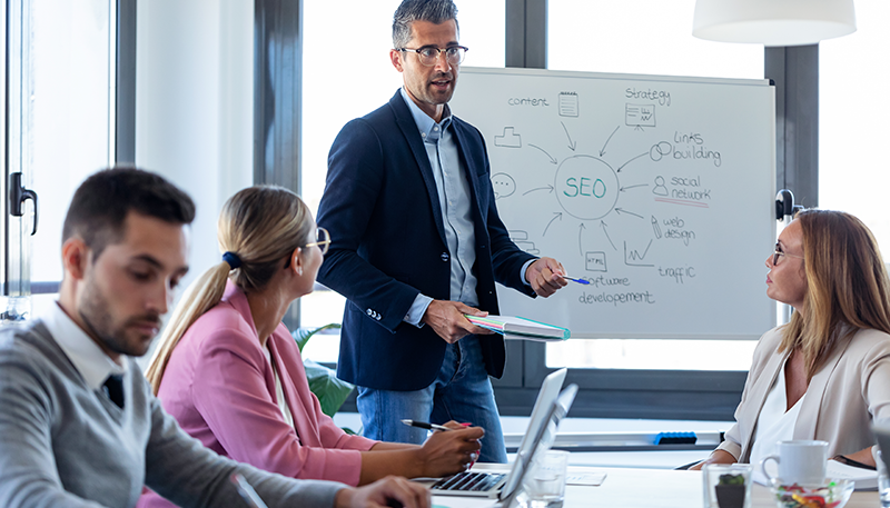 Businessman explaining SEo to a group