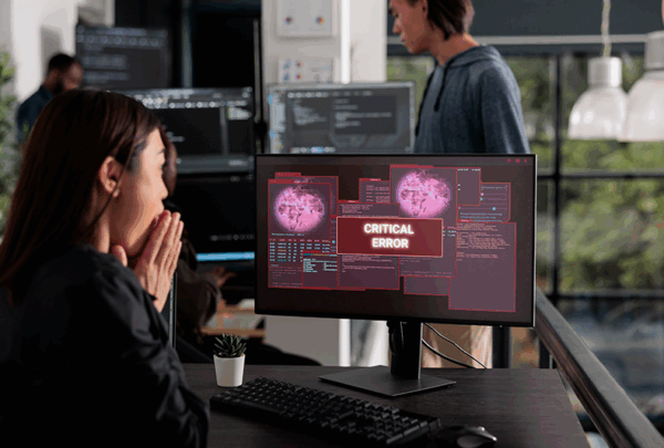 lady at computer with virus message on screen