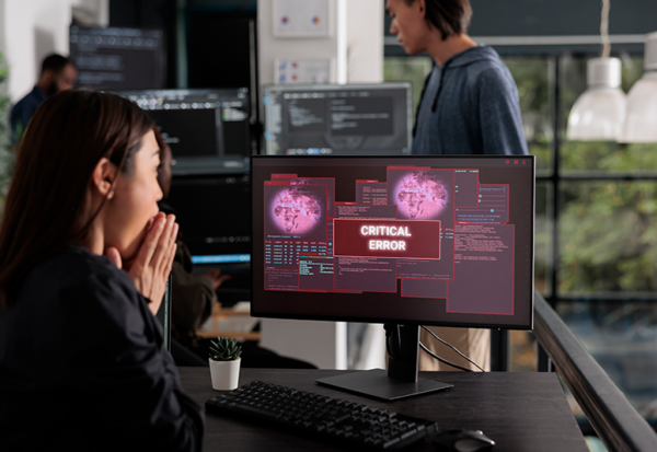 lady at computer with virus message on screen