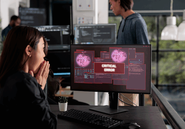 lady at computer with virus message on screen