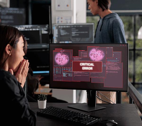lady at computer with virus message on screen