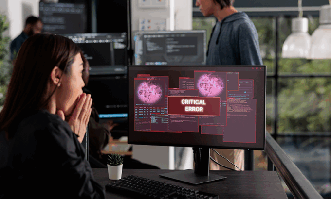 lady at computer with virus message on screen