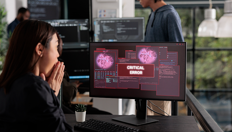 lady at computer with virus message on screen