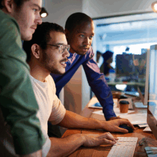 men working on a website at a computer