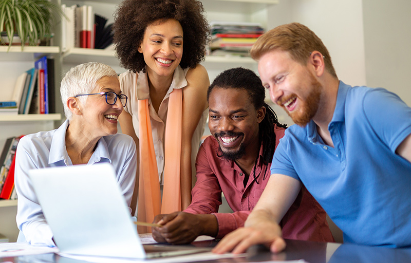 Group of people looking at a laptop computer