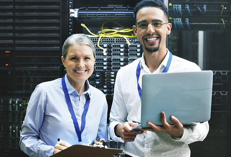 Two workers standing in front of a server